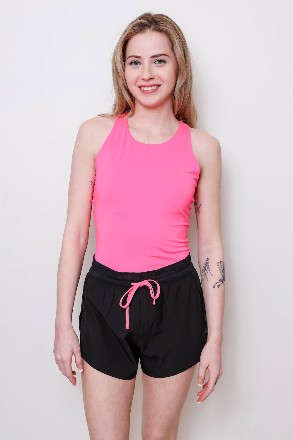 Women's pink running pocket tank front view